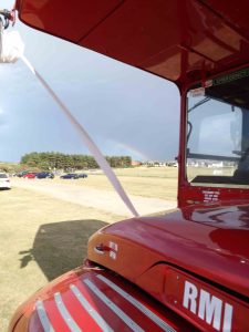 Rainbow in distance of double decker