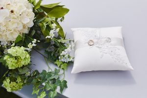 Wedding bands on pillow by Bushfire Photography